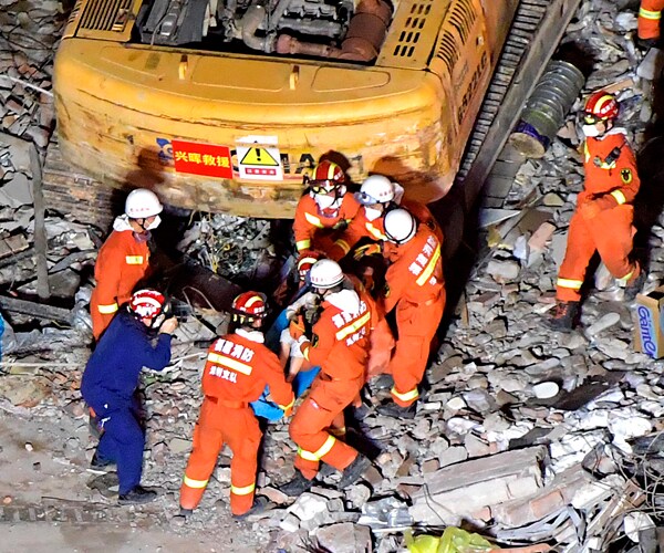 a mother and her son are rescued from a collapsed hotel in quanzhou china