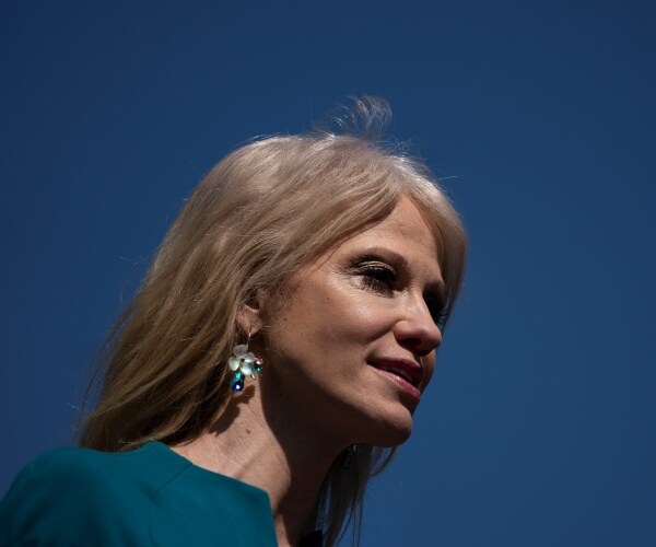 kellyanne conway wearing earrings and a teal dress