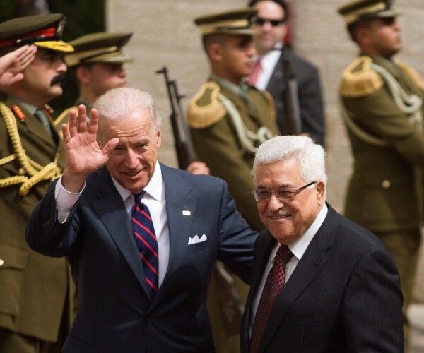 biden and mahmoud abbas meet with soldiers in the background