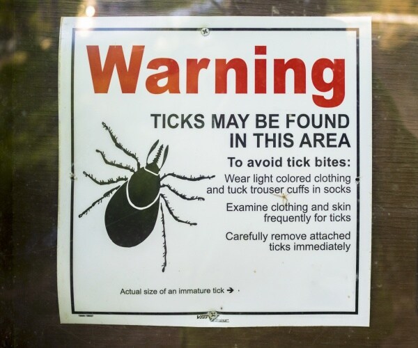 tick warning sign is shown