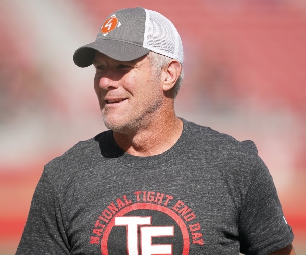 favre in a gray t shirt and baseball hat
