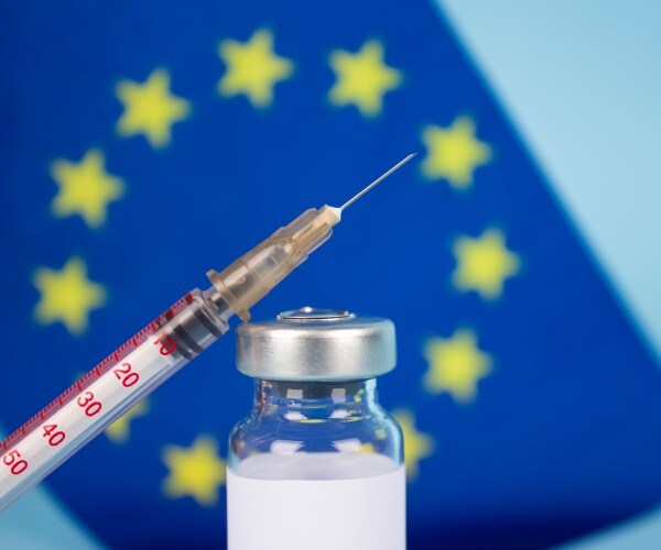 COVID vaccine vial, EU flag