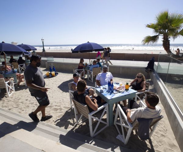 Alarmed by Soaring COVID-19 Hospitalizations, Some US States Tighten Curbs