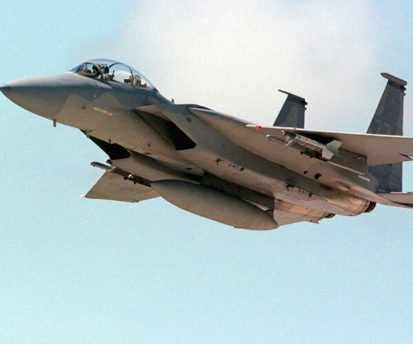 an f-15 jet fighter ascends into the sky over the kadena air base on okinawa, japan