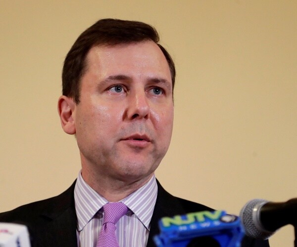 tom kean speaks into microphone