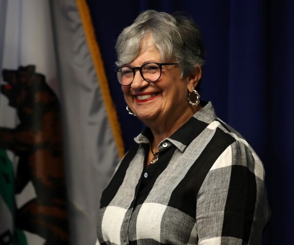 nichols in a black white and gray button down top