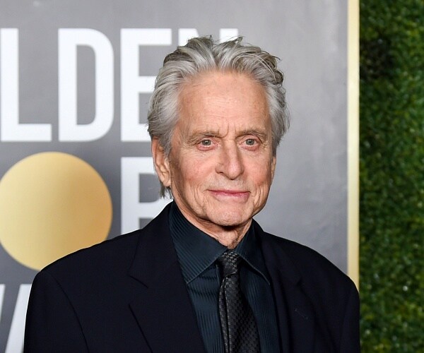 michael douglas stands on red carpet