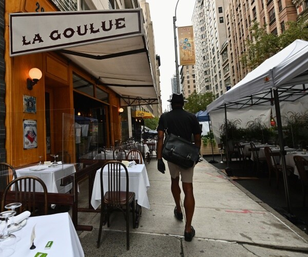 a person walks past restaurant