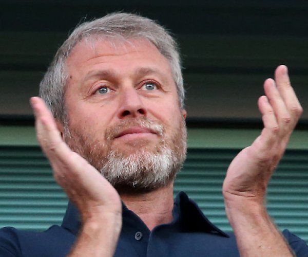 roman abramovich applauds at a soccer match in london