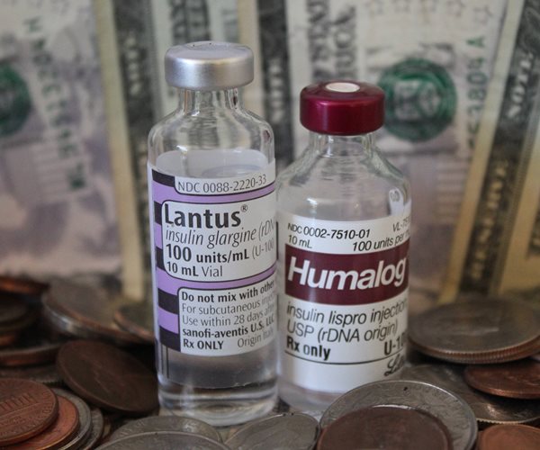 Insulin vials surrounded by money.