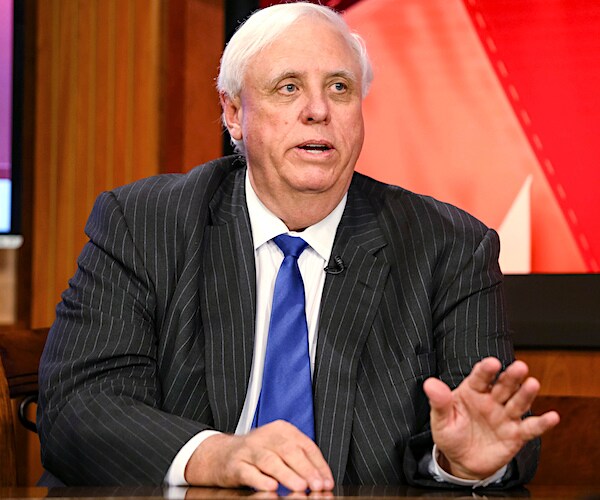 jim justice holds up his left hand to say stop as he speaks with the media