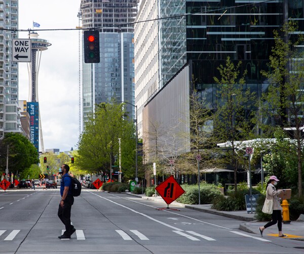 people walk on a street in seattle