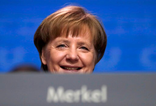 The Latest: Merkel Welcomes Center-left's OK for Coalition