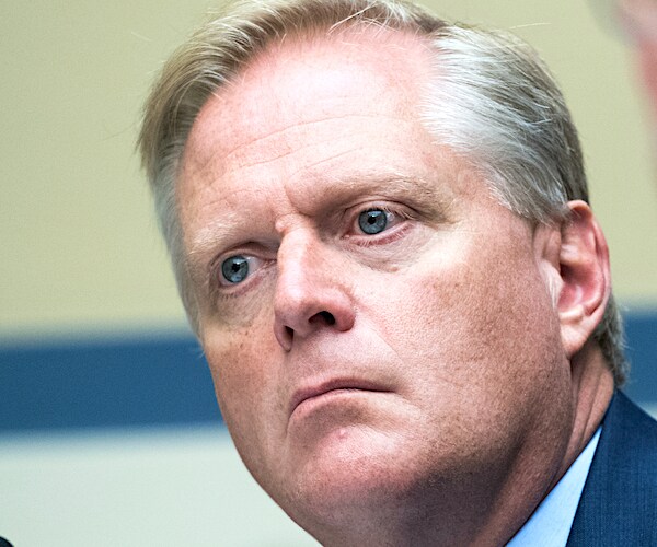 fred keller looks to his left while listening to a question during a hearing