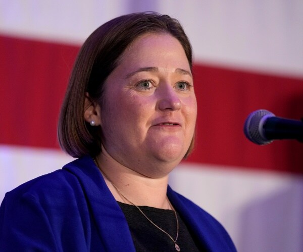 brenna bird looks on