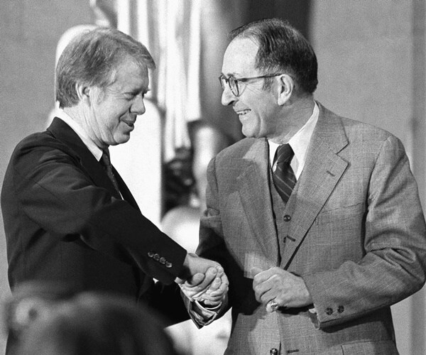 president jimmy carter shakes griffin bell's hand after he is sworn in as ag