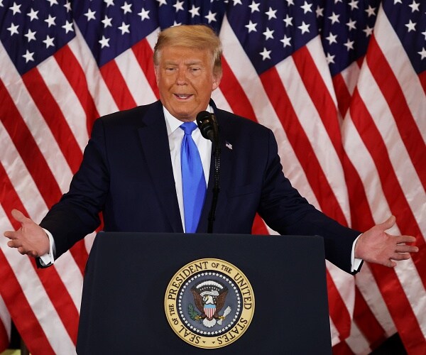 donald trump stands behind podium