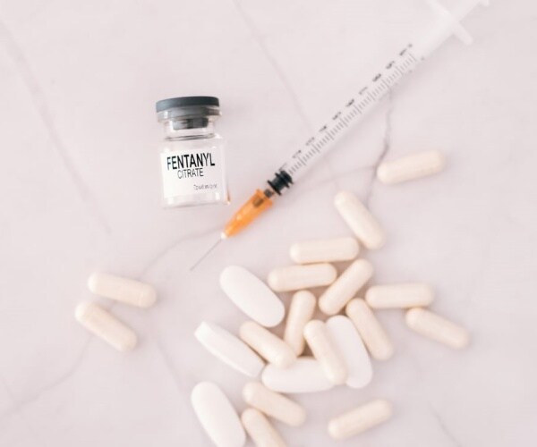 syringe, pills, vial of fentanyl