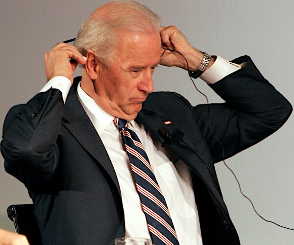joe biden puts on headphones before a summit when he was vice president