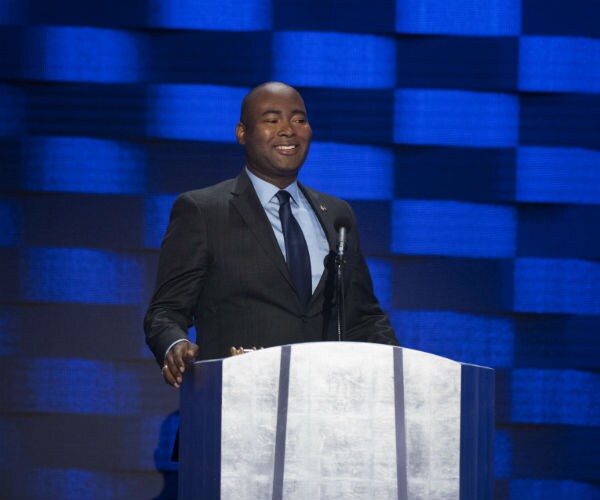 Democratic Jaime Harrison is shown speaking at a podium.