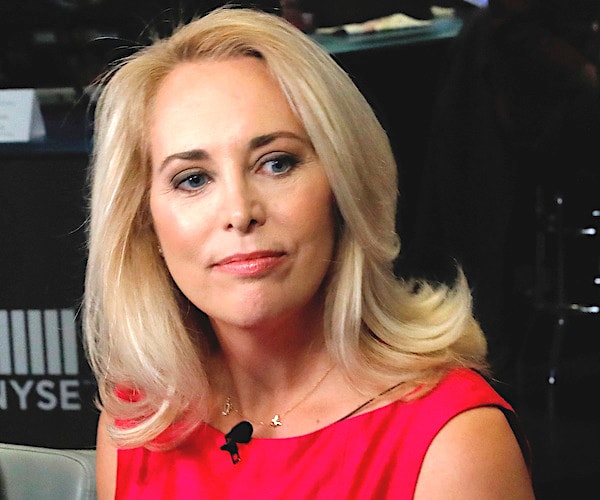 former CIA operative Valerie Plame looks to her left to listen while making a television appearance