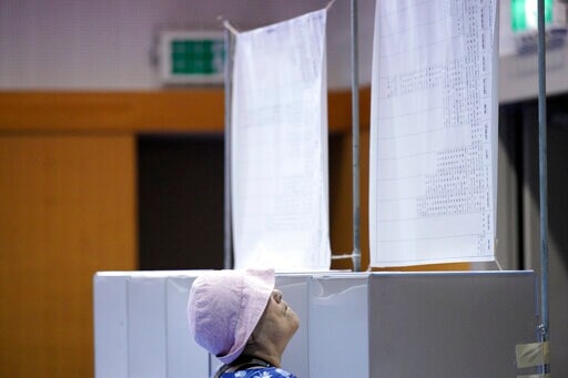 The Latest: Exit Polls Show Abe's Ruling Bloc Wins Elections