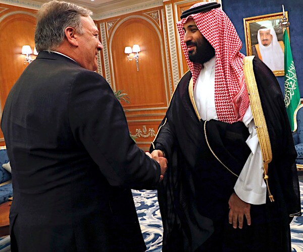 secretary of state mike pompeo with his back to the camera shakes the right hand of the saudi arabia crown prince