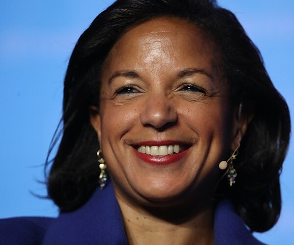 susan rice smiles against a blue background