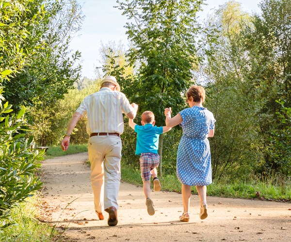 grandparents walking with their grandchild