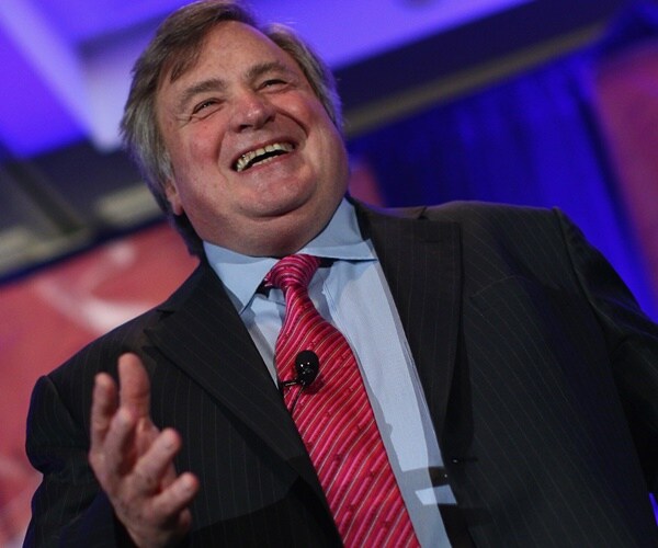 dick morris is on stage smiling