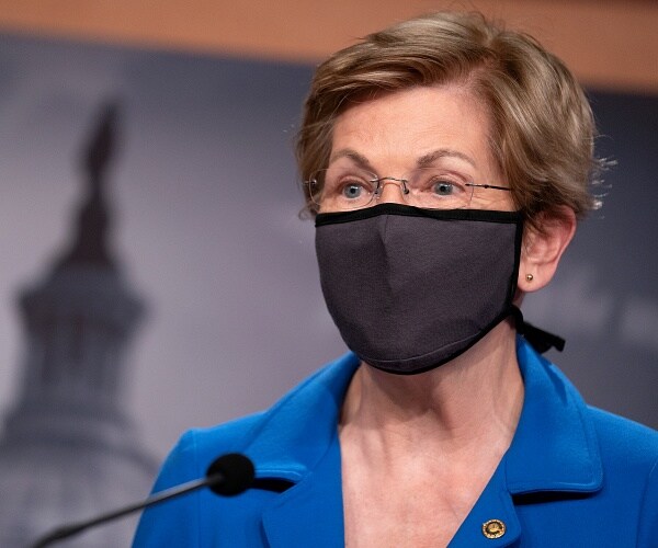 elizabeth warren speaks into microphone