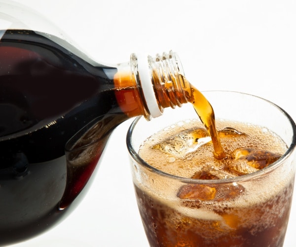 pouring soda into a glass