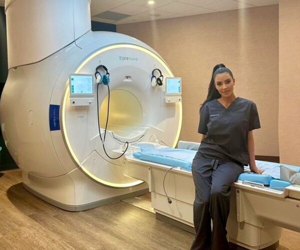 Kim Kardashian next to MRI machine where she received a whole-body MRI scan
