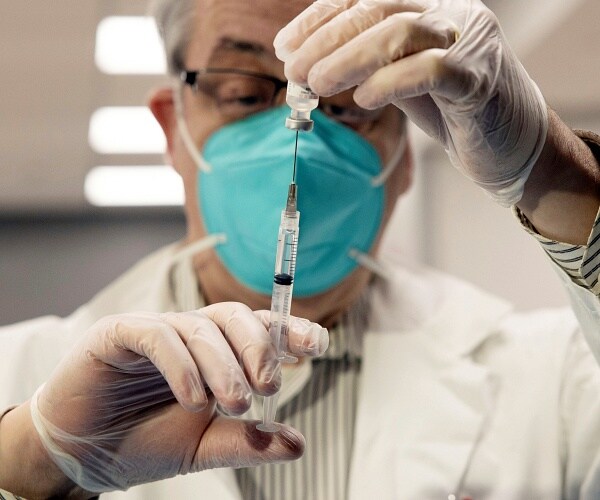 pharmacist prepares vaccine