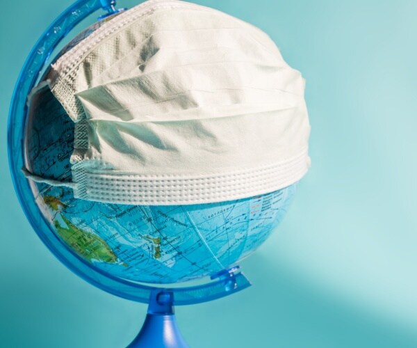 globe on a stand with a surgical mask