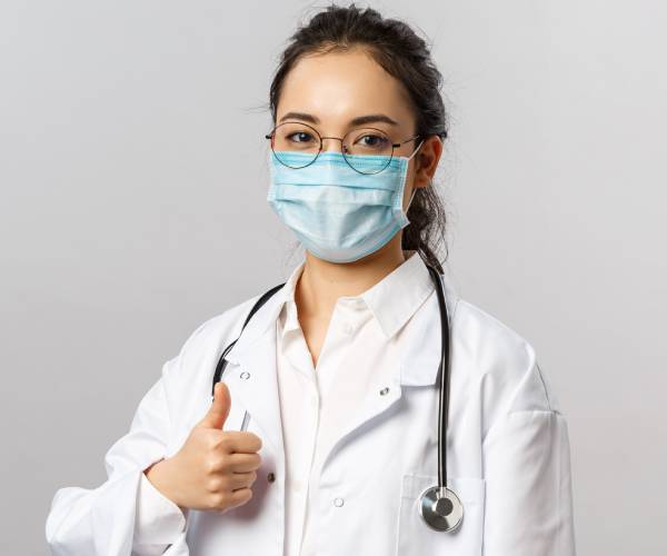 medical professional giving the thumbs up