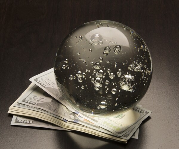 crystal ball and money on a black background 