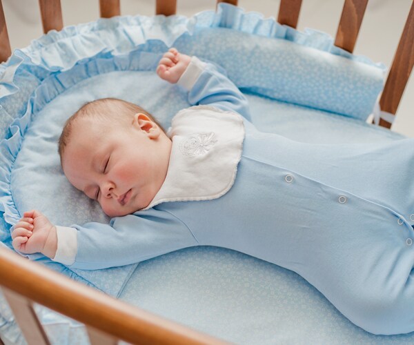 newborn baby sleeping in crib