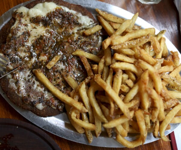a steak is shown with french fries