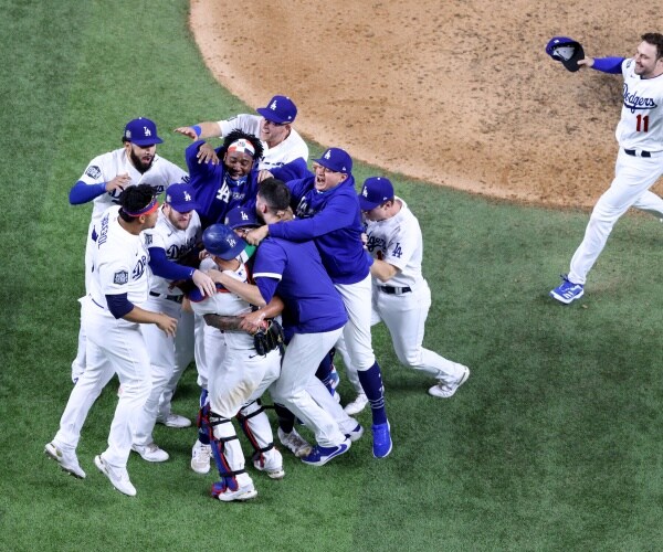 dodgers celebrate winning the game on the baseball field