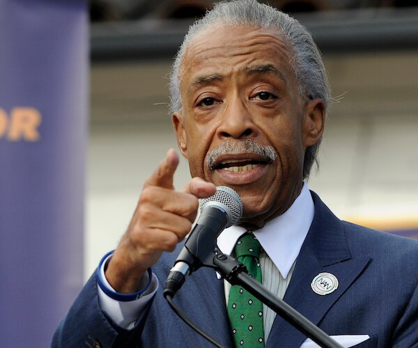 al sharpton points and speaks to a congregation