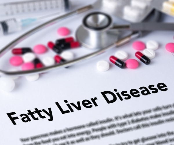 entry in medical book for Fatty Liver Disease, pills, stethoscope