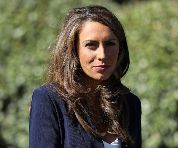 alyssa farah stands in driveway