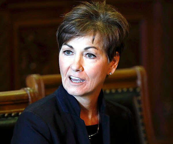 republican iowa governor kim reynolds turns her head to the right while delivering remarks