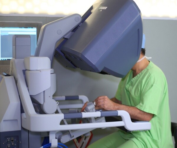 doctor at control of robotic surgical system