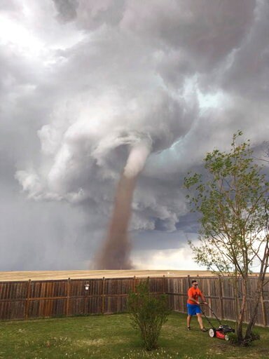 Canadian Man Mows Lawn with Tornado behind Him
