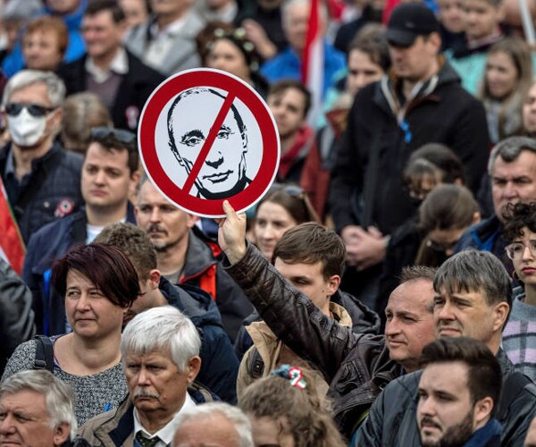 an anti putin placard is displayed at a protest in budapest in march