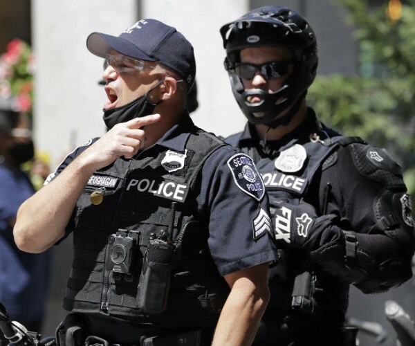 two seattle police officers are seen on patrol in july