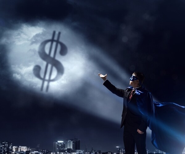 superhero man dressed in black pointing to dollar sign in sky
