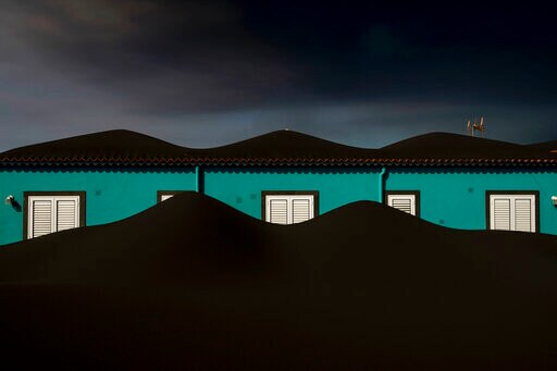 AP PHOTOS: A Slow Motion Burial Awaits in Volcano No-go Zone